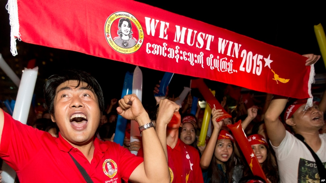 Supporters of Myanmar's National League for Democracy party cheer as election results are posted outside the NLD headquarters in Yangon, Myanmar, Nov. 9, 2015. 