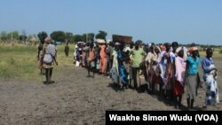 Hundreds of people wait in line in the town of Koch in South Sudan's Unity state to receive food aid from the World Food Program on Friday, Sept. 25, 2015. Aid agencies resumed deliveries to the war-torn area after a four-month break precipitated by an uptick in fighting. 