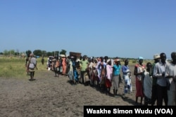FILE - Hundreds of people wait in line in the town of Koch in South Sudan to receive food aid from the World Food Program on Friday, Aug. 25, 2015. Aid agencies stopped deliveries to Koch in May, after a sharp surge in violence there.