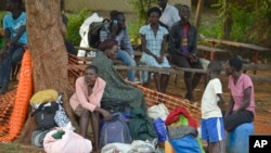 FILE - People take shelter near the All Saints Church in Juba, South Sudan, July 12, 2016.