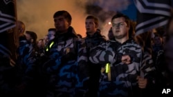 FILE - Members of nationalist movements attend a rally marking Defender of Ukraine Day, in Kyiv, Ukraine, Oct. 14, 2018. 