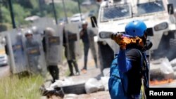 A demonstrator throws a molotov cocktail at security forces during clashes at a rally against Venezuelan President Nicolas Maduro's government in Caracas, Venezuela, July 18, 2017. 