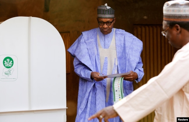 Nigerian President Muhammadu Buhari prepares to cast his vote in Nigeria's election at a polling station in Daura, Katsina State, Nigeria, Feb. 23, 2019.