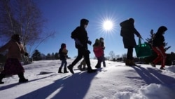 Cindy Soule's fourth grade class heads outside to study snowflakes at the Gerald Talbot School, in Portland, Maine. Photo taken on Monday, December 8, 2020. (AP Photo/Robert F. Bukaty)