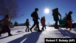 Cindy Soule's fourth grade class heads outside to study snowflakes at the Gerald Talbot School, in Portland, Maine. Photo taken on Monday, December 8, 2020. (AP Photo/Robert F. Bukaty)