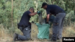 Israeli police inspect debris from what the military said was a Syrian drone that it shot down near the Sea of Galilee, in northern Israel July 11, 2018.