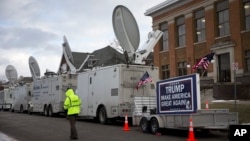 FILE - A trailer with a sign supporting Republican presidential candidate Donald Trump, and satellite trucks, are parked on the campus of Drake University in Des Moines, Iowa, Jan. 28, 2016, where Trump is scheduled to hold a campaign event. 
