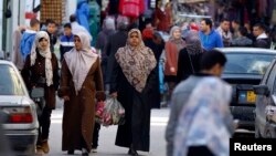 FILE - Women shop in the souq (market) of the old city in Tripoli, February 13, 2012. 