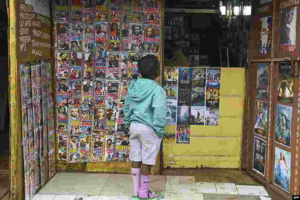 나이로비에서 가장 거대한 빈민가인 키베라의 비디오 가게에서 어린 소년이 최근 출시된 DVD의 사진을 보고있다.