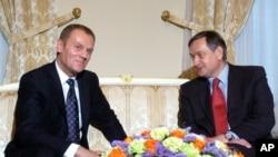 FILE - Polish Prime Minister Donald Tusk, left, talks with Slovenian President Danilo Turk, Presidential palace, Ljubljana, Slovenia, March 2008.