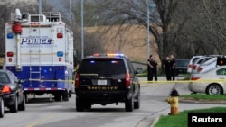 FILE - Police officers gather at the scene of a shooting at the Jewish Community Center of Greater Kansas City in Overland Park, Kan., April 13, 2014. 