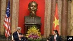 FILE - U.S. Secretary of State John Kerry, left, and Vietnamese President Truong Tan Sang talks during a meeting at the Presidential Palace in Hanoi, Vietnam, Friday, Aug. 7, 2015.