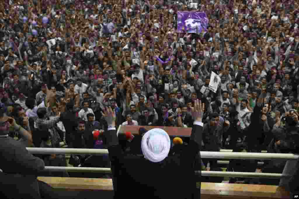 Iranian presidential candidate Hasan Rowhani waves to his supporters during his speech in a campaign rally, Oroumieh, Iran, June 10, 2013. 