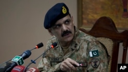 FILE - Pakistan's army spokesman Major-General Asim Bajwa briefs the media about a Taliban attack on a school in Peshawar, Pakistan, Dec. 16, 2014.