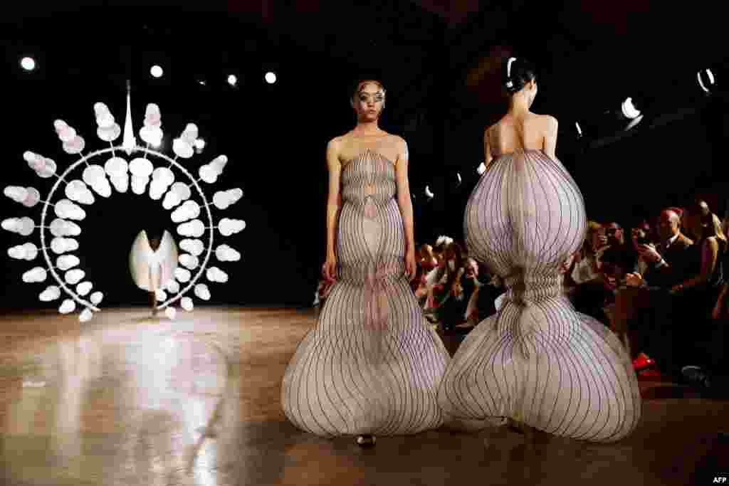 Models present creations by Iris van Herpen during the Women's Fall-Winter 2019/2020 Haute Couture collection fashion show in Paris, France.