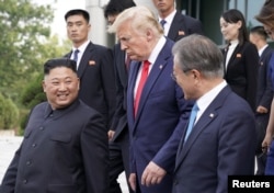 U.S. President Donald Trump, North Korean leader Kim Jong Un and South Korean President Moon Jae-in leave after a meeting at the demilitarized zone separating the two Koreas, in Panmunjom, South Korea, June 30, 2019.