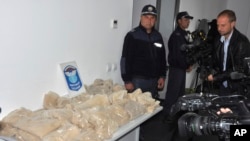 FILE - Bulgarian customs officers display part of 712 kg of heroin, Sept. 29, 2018, in Kapitan Andreevo. The drugs were found in Iranian trucks. On April 18, 2019, prosecutors said Bulgarian officials had confiscated more than 288 kg of heroin from another truck from Iran.