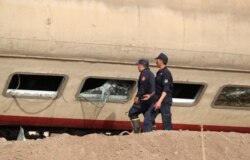 Petugas memeriksa kerusakan kereta api yang kecelakaan di provinsi Qalioubia, utara Kairo, Mesir, 18 April 2021. (REUTERS/Mohamed Abd El Ghany)