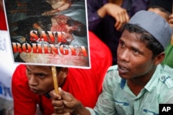 An ethnic Rohingya holds a placard during protest after prayers outside the Myanmar Embassy in Kuala Lumpur, Malaysia, Nov. 25, 2016.