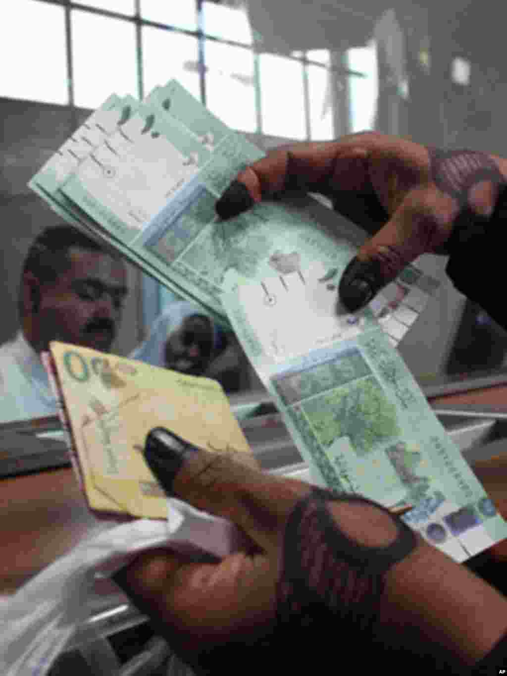 President Kiir should know the difference between cows and money. How come he kept money in his compound like cows and yet we have safe places like banks for him to save his save his money? Keeping money in the office is a sign of corruption. - James Ruei Majok in Unity state A woman displays Sudan&#39;s new currency at the central bank in Khartoum, Sudan, in July 2011.