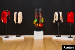 Outfits belonging to musicians Michael Jackson, Elvis Presley, Sly Stone and Jimmy Page are displayed as part of a collection from; 'A Rock and Roll History: Presley to Punk' at Sotheby's auction house in New York, June 20, 2014.