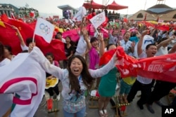 Residents celebrate as Beijing is announced as the host city for the 2022 Winter Olympics at the ski resort region of Chongli where the outdoor Olympic events will be held in Hebei province, July 31, 2013.