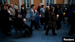 People hold candles as they march during the 9th anniversary of Pope John Paul II's death in Wadowice, the birth place of the Polish Pope, Apr. 2, 2014.