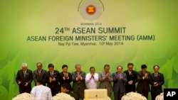 Foreign Ministers and representatives of Association of Southeast Asian Nations, applaud after posing for a group photo during the 24th ASEAN summit in Naypyitaw, Myanmar, Saturday, May 10 2014.