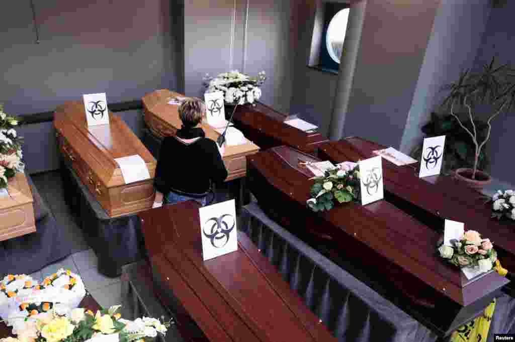 Biohazard warning signs are placed on the coffins of people who died of the coronavirus disease (COVID-19), at a mortuary near the city of Charleroi, Belgium.