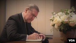 William Cohen, signs the condolence book for His Majesty King Bhumibol Adulyadej.