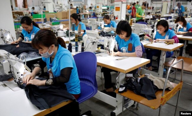 Laborers work at export garment Maxport factory in Hanoi, Vietnam, March 20, 2019.