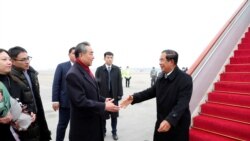 Chinese State Councilor and Foreign Minister Wang Yi welcomes Cambodian Prime Minister Hun Sen as he arrives at the Beijing Capital International Airport in Beijing, China February 5, 2020.