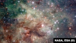 NASA's Hubble space telescope has taken this stunning close-up shot of part of the Tarantula Nebula. This star-forming region of ionized hydrogen gas is in the Large Magellanic Cloud, a small galaxy which neighbors the Milky Way. (NASA/ESA)