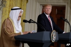 President Donald Trump listens while Kuwait leader Sheikh Sabah Al-Ahmad Al-Jaber Al-Sabah speaks during a news conference at the White House in Washington, Sept. 7, 2017.