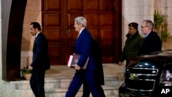 U.S. Secretary of State John Kerry, center, arrives to the West Bank city of Ramallah, Tuesday, Nov. 24, 2015, to meet with Palestinian President Mahmoud Abbas.