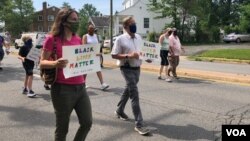 Julia Young, marching with her father Malcolm, in an Arlington, Virginia, “Say Their Names” protest against police brutality. (VOA/Carolyn Presutti)