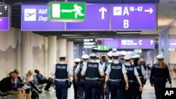FILE - German police officers walk in a terminal at the airport in Frankfurt, Germany, March 23, 2016.