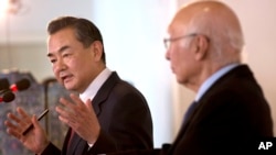 Chinese Foreign Minister Wang Yi, left, speaks during a meeting with Pakistan's Prime Minister's Adviser on Foreign Affairs Sartaj Aziz, in Islamabad, Pakistan, Feb. 12, 2015.