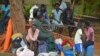 FILE - People take shelter near the All Saints Church in Juba, South Sudan, July 12, 2016.