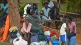 FILE - People take shelter near the All Saints Church in Juba, South Sudan, July 12, 2016.