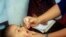 Child receiving polio vaccine.