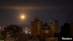 An explosion of a drone is seen in the sky over the city during a Russian drone strike in Kyiv, Ukraine Sept. 30, 2024.