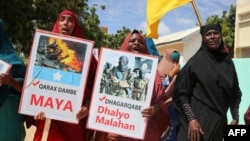 Somali women chant slogans and hold placards written in Somali "No more Explosions" and "Silly criminal is Dangerous" as they protest against Somali Islamist group Al-Shabaab in Mogadishu on Jan. 2, 2020.