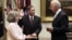 Holly Knowlton Petraeus holding the family bible as her husband David Petraeus is sworn in by Vice President Joe Biden as CIA Director, in the Roosevelt Room of the White House in Washington, September 6, 2011.