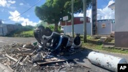 An overturned car is pictured in Le Gosier, Guadeloupe island, Nov. 21, 2021, after protests over COVID-19 restrictions erupted into rioting.