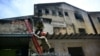 Firefighters leave after extinguishing a fire in a textile factory that specializes in making Carnival costumes and police uniforms in the northern part of Rio de Janeiro, Brazil, on Feb. 12, 2025.