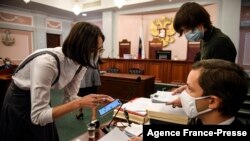 Lawyers for the Memorial rights group speak before a hearing at Russia's Supreme Court in Moscow, Nov. 25, 2021.