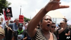 Demonstrators take part in a protest march across the Nelson Mandela bridge into Johannesburg, South Africa, Dec. 16, 2015. 