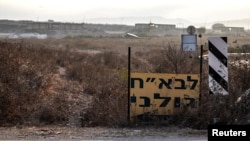 FILE - A sign in Hebrew shows the direction to a military base in Binyamina, Israel, Oct. 14, 2024. 