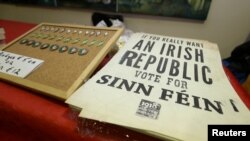 FILE - Sinn Fein souvenirs are displayed for sale before a public meeting at Liberty Hall in Dublin, Ireland, Feb. 25, 2020.